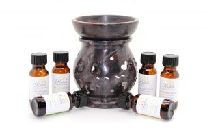 Image of a burner and six bottles of essential oils