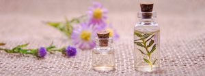 Cellulite - 2 bottles of essential oils and flowers on a table