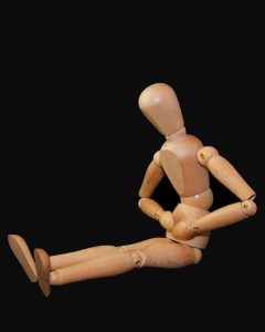 Stomach ache - wooden figure clutching belly