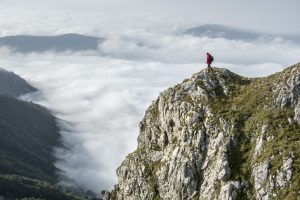 Image of a backpacker on a tall mountain
