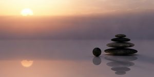 Ayurveda - Stones balanced atop one another on the beach