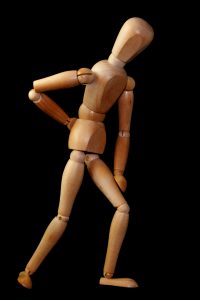 Back pain - Image of Wooden figure clutching back
