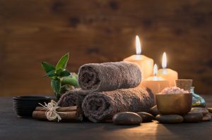 Massage - Image of candles, towels, stones