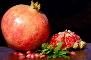Photo of whole pomegranate and inside of anoth