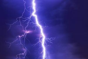 TENS - Image of a lightning bolt against a dark blue sky