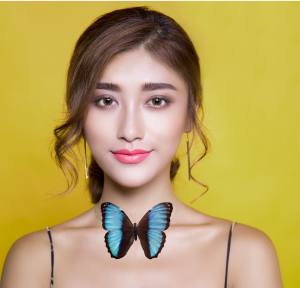 Image of a girl with a butterfly at her neck