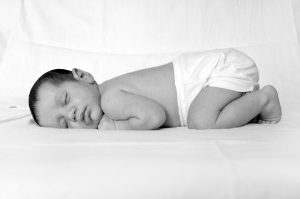 Image of a baby in diapers sleeping peacefully