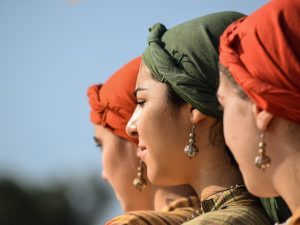 Image of three women with head scarves and pierced ears