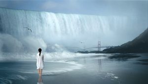picture of a girl standing on a beach watching a wall of water wash over the golden gate bridge
